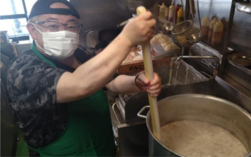 神奈川県・東京多摩エリアで展開する鶏とんこつ醤油ラーメン店「七志」では、毎月開催している体験型イベント「大人ラーメン教室」「親子ラーメン教室」が好評を博しています。運営する株式会社ナナシフードサービス(本社:横浜市青葉区)によると、累計受講者数は5,000人を突破し、昨年度比で150%の増加を記録したそうです。写真は寸胴鍋でスープを混ぜる店員さんの様子